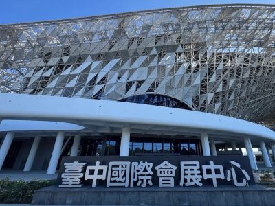 679028188_979690061251599_2056174421863144573_n Taichung International Convention and Exhibition Center exterior with a lattice metal roof and a large sign in front.